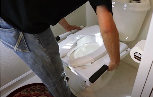 Install Mechanical toilet seat lift with handles - Bring the tilt frame and set it on the toilet bowl
