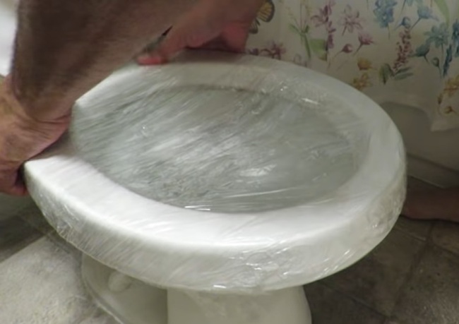 How to Unclog a Toilet with Saran Wrap - Cover the sides