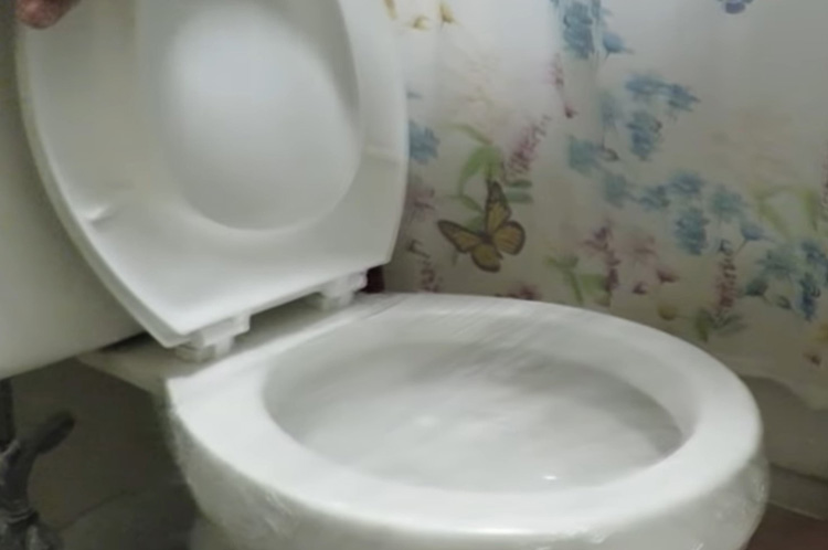 How to Unclog a Toilet with Saran Wrap - Cover the bowl with Wrap